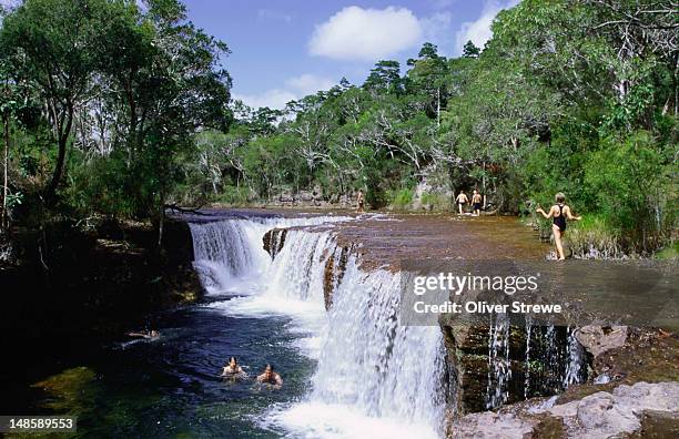 enjoying a dip in the clear waters at eliot falls, in the northern tip of cape york peninsula - queensland-del-norte fotografías e imágenes de stock