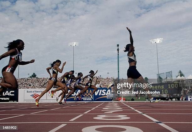 Marion Jones of the USA celebrates after crossing the finish line in first place during the Women's 100 meter Event of the 2000 U.S. Olympic Track &...