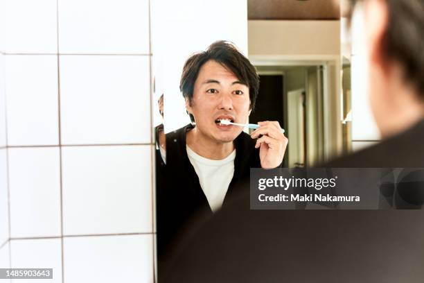 japanese man brushing his teeth - buccal cavity stock pictures, royalty-free photos & images