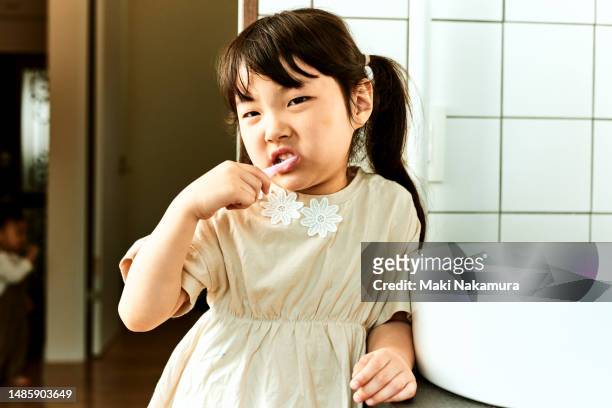 japanese kindergarten girl brushing teeth - buccal cavity stock pictures, royalty-free photos & images