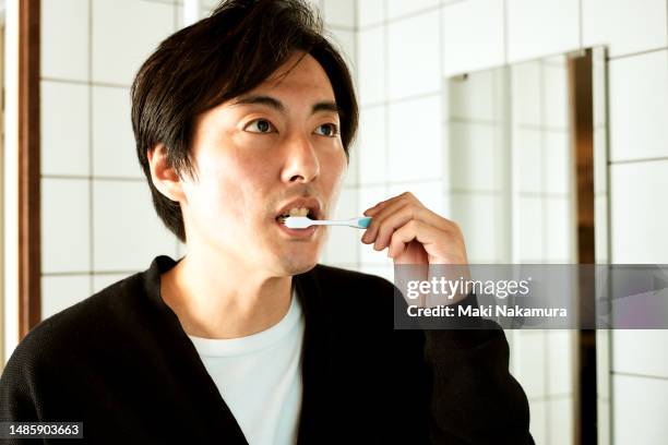 japanese man brushing his teeth - buccal cavity stock pictures, royalty-free photos & images