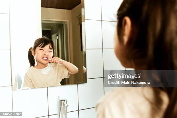 japanese kindergarten girl brushing teeth - buccal cavity stock pictures, royalty-free photos & images