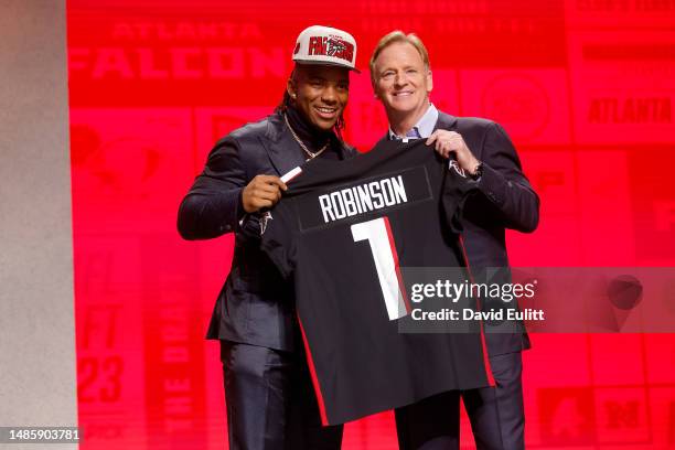Bijan Robinson poses with NFL Commissioner Roger Goodell after being selected eight overall by the Atlanta Falcons during the first round of the 2023...