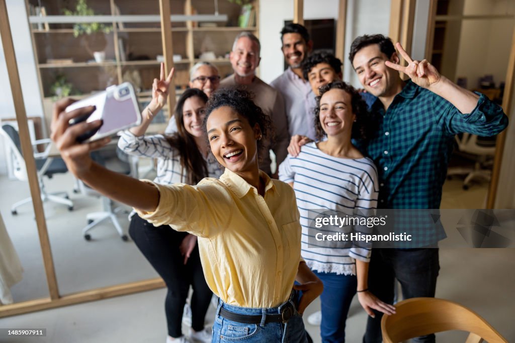 Happy business team taking a selfie at the office