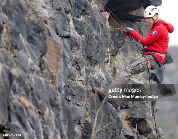 Prince William, Prince of Wales takes part in a Central Beacons Mountain Rescue Team abseiling training exercise on April 27, 2023 in Merthyr Tydfil,...