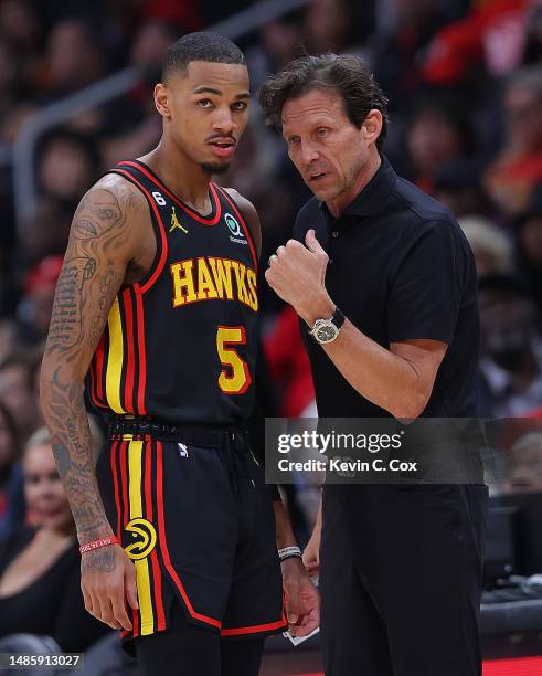 Head coach Quin Snyder of the Atlanta Hawks converses with Dejounte Murray against the Boston Celtics during the second quarter of Game Six of the...