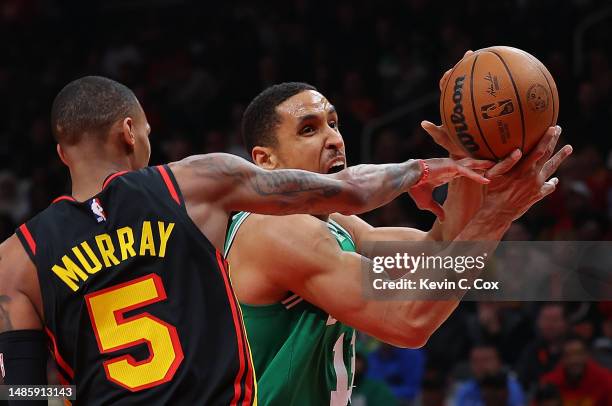 Malcolm Brogdon of the Boston Celtics draws a foul as he drives against Dejounte Murray of the Atlanta Hawks during the second quarter of Game Six of...
