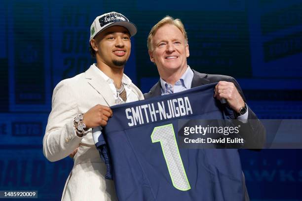 Jaxon Smith-Njigba poses with NFL Commissioner Roger Goodell after being selected 20th overall by the Seattle Seahawks during the first round of the...