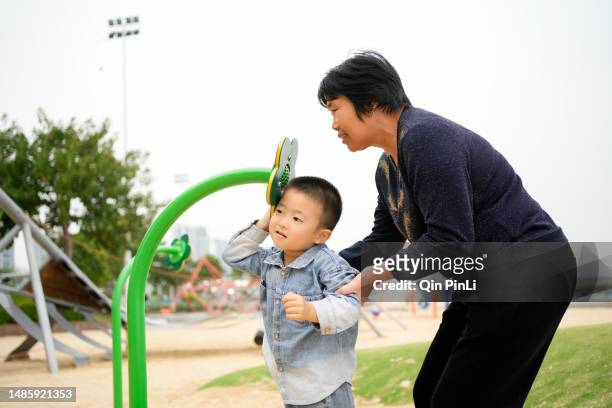 grandma played the trumpet with her grandson in the park - 家庭 stock pictures, royalty-free photos & images