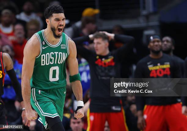 Jayson Tatum of the Boston Celtics reacts after dunking the ball on a rebound against the Atlanta Hawks during the fourth quarter of Game Six of the...