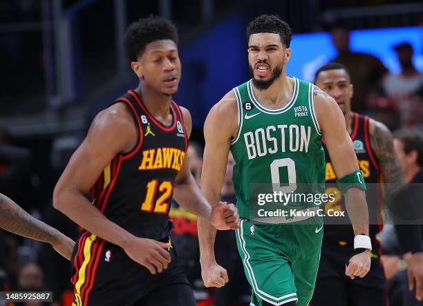 Jayson Tatum of the Boston Celtics reacts after dunking the ball on a rebound against the Atlanta Hawks during the fourth quarter of Game Six of the...