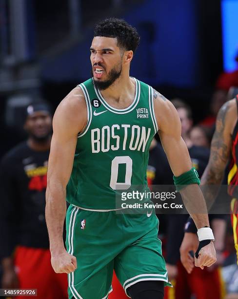 Jayson Tatum of the Boston Celtics reacts after dunking the ball on a rebound against the Atlanta Hawks during the fourth quarter of Game Six of the...