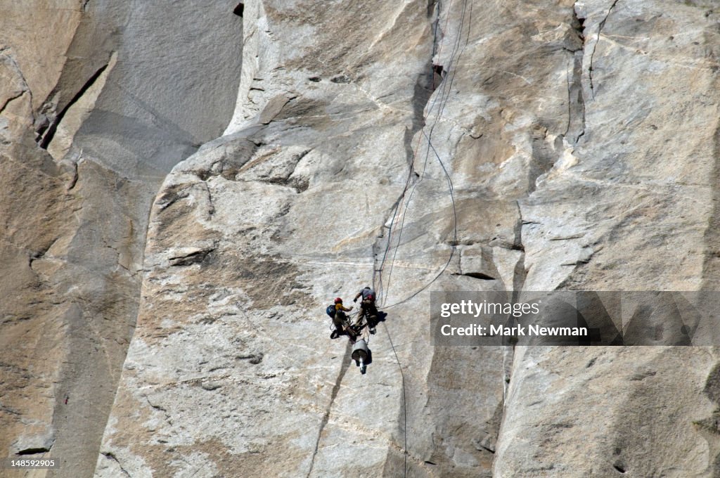 Rock climbers ascending El Capitan cliff face.