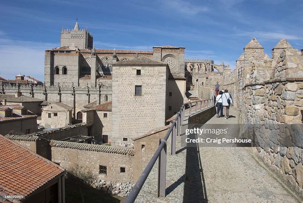 People walking along top of city walls.