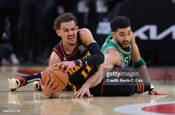 Trae Young of the Atlanta Hawks grabs a loose ball against Jayson Tatum of the Boston Celtics during the fourth quarter of Game Six of the Eastern...