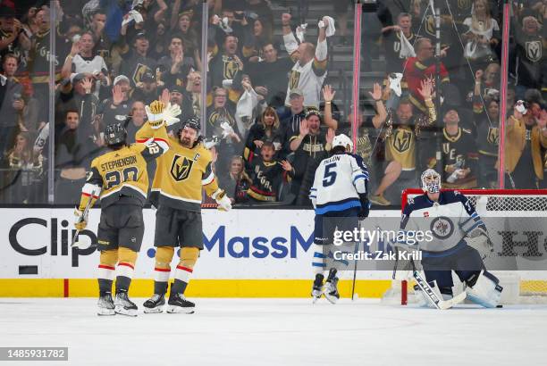 Chandler Stephenson of the Vegas Golden Knights celebrates with teammates after a goal during the second period against the Winnipeg Jets in Game...