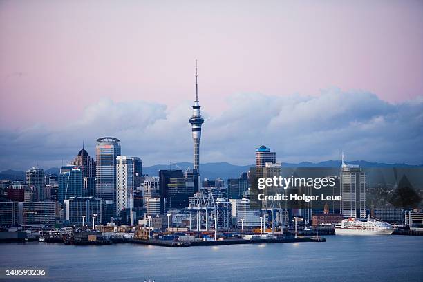 city skyline with cruiseship mv columbus at sunrise. - auckland new zealand stock pictures, royalty-free photos & images