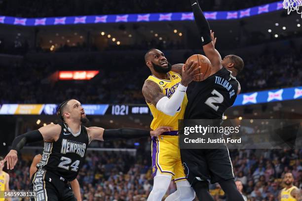 LeBron James of the Los Angeles Lakers goes to the basket against Xavier Tillman of the Memphis Grizzlies and Dillon Brooks of the Memphis Grizzlies...