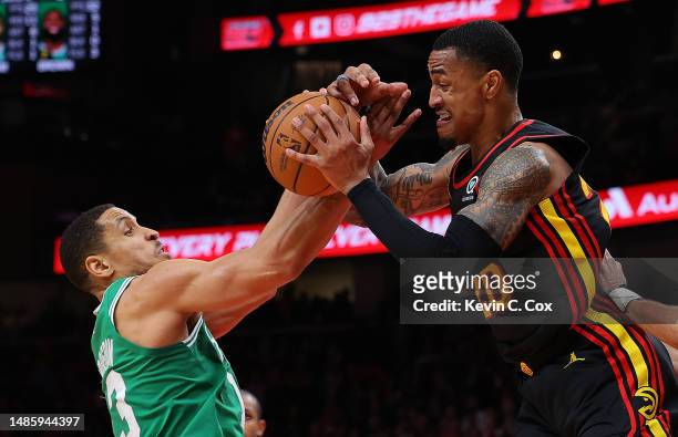 Malcolm Brogdon of the Boston Celtics strips the ball from John Collins of the Atlanta Hawks during the fourth quarter of Game Six of the Eastern...