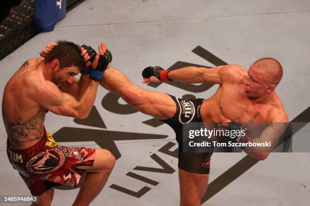 Georges St-Pierre throws and lands a kick against Carlos Condit in their welterweight title bout during UFC 154 on November 17, 2012 at the Bell...