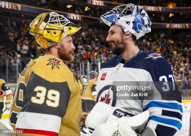 Laurent Brossoit of the Vegas Golden Knights and Connor Hellebuyck of the Winnipeg Jets talk after the conclusion of Game Five of the First Round of...