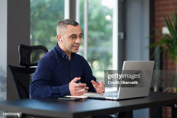 adult student studying remotely from home using laptop computer - self discipline stock pictures, royalty-free photos & images