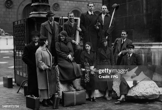 The ten candidates for the 1935 Grand Prix de Rome painting prize pose alongside a guard holding a set of keys at the Beaux-Arts de Paris, in Paris,...