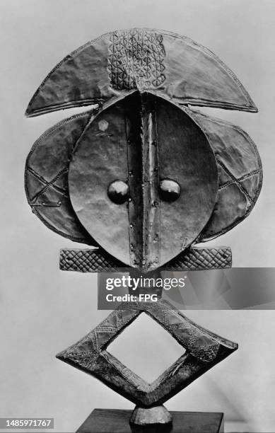 Tribal mask, made from wood overlaid copper, from the Ogave River Region in the Gabon section of the 'Exhibition of African Tribal Art' at the Museum...