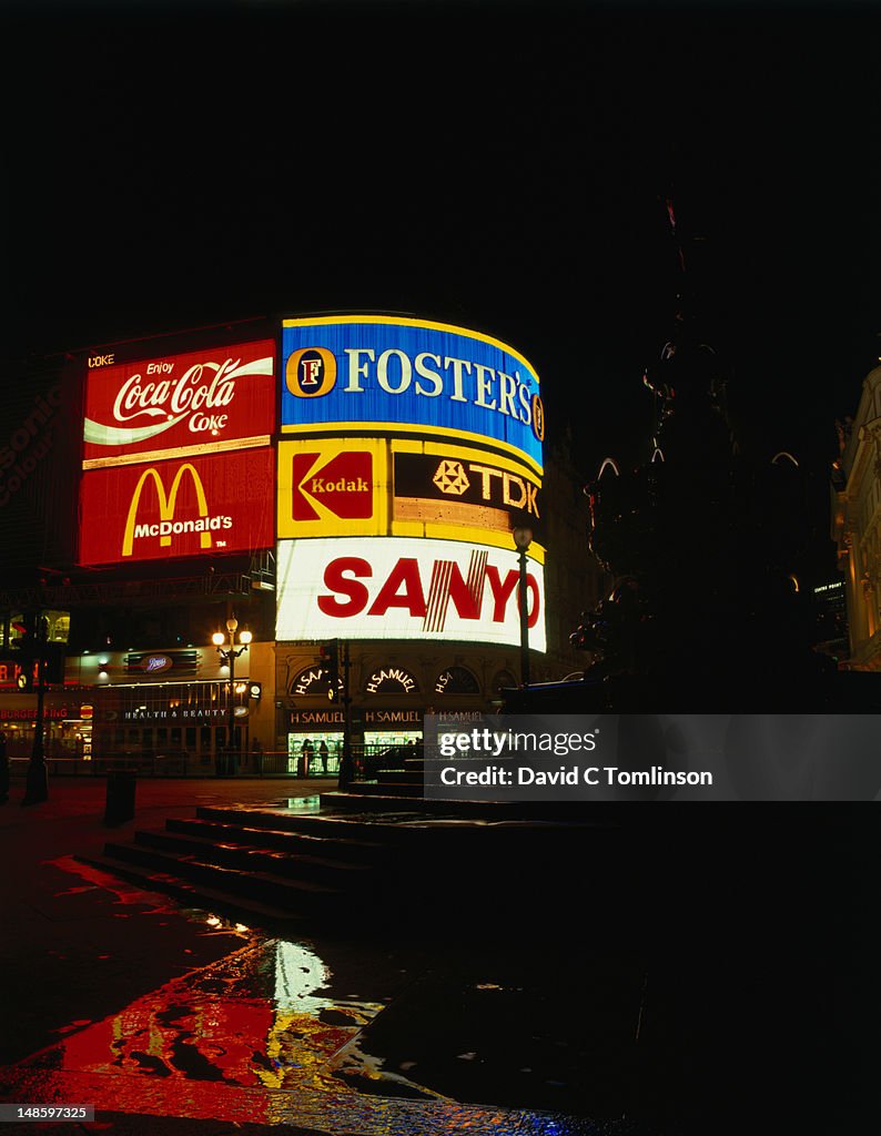 Advertising lights up Piccadilly Circus at night.