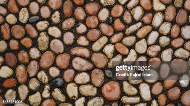 abstract dry pebbles stones warm toned background - gravel floor stock pictures, royalty-free photos & images