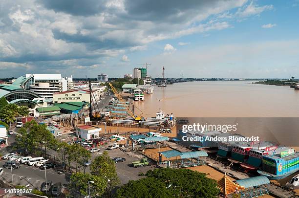 aerial of town waterfront and muddy batang rejang river. - sibu river stock pictures, royalty-free photos & images