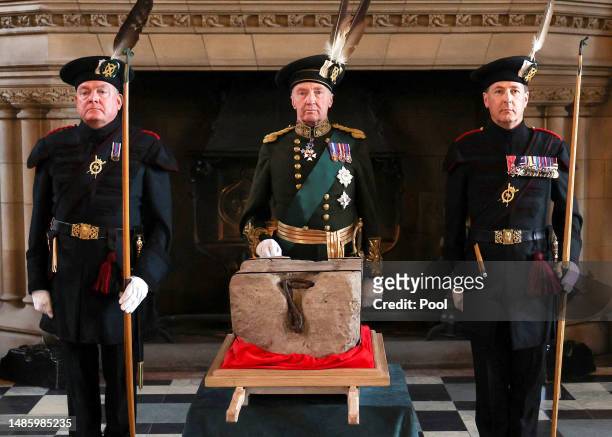The Duke of Buccleuch flanked by two members of The Royal Company of Archers stand by the Stone of Destiny in Edinburgh Castle before onward...