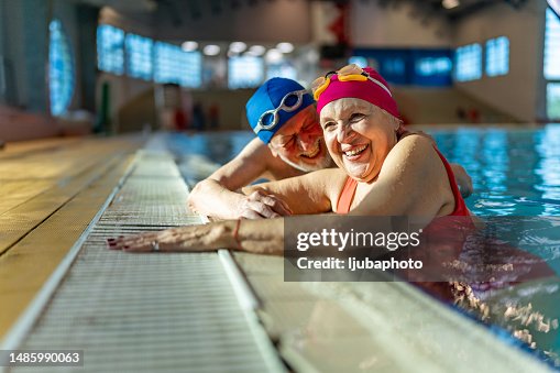 Two senior friends hanging out together in the swimming pool. Two senior friends hanging out together in the swimming pool.
