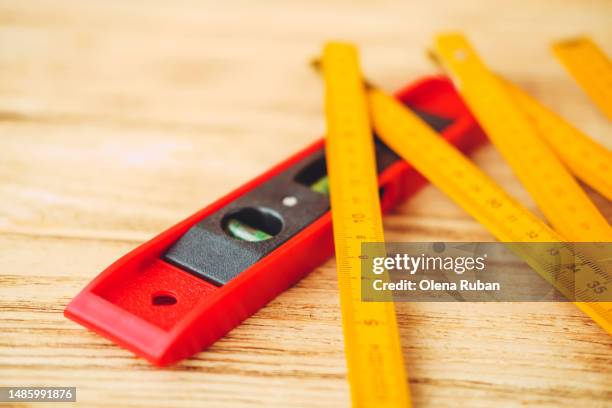 folding rule over level tool. - duimstok stockfoto's en -beelden