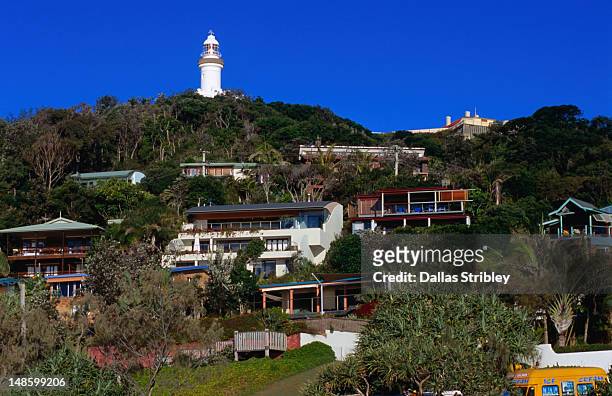 cape byron lighthouse above wategos beach houses. - byron bay imagens e fotografias de stock