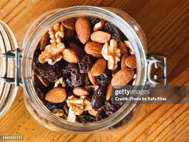 nuts in glass pot - raisin stock pictures, royalty-free photos & images