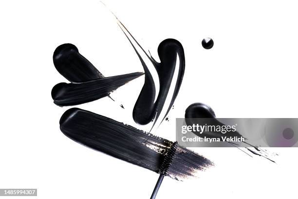 black smear of black eye liner from a mascara brush on white background, isolated. cosmetic make-up products for eyelashes. - eyeliner stock pictures, royalty-free photos & images