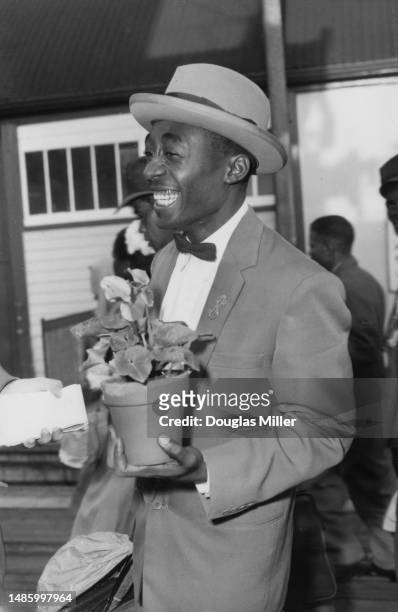 An immigrant from Jamaica carries a plant pot on arrival at Newhaven, East Sussex, September 22nd 1958. He is one of a group of 583 Jamaicans to...