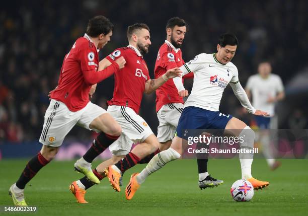 Son Heung-Min of Tottenham Hotspur battles for the ball with Luke Shaw, Bruno Fernandes and Victor Lindelof of Manchester United during the Premier...