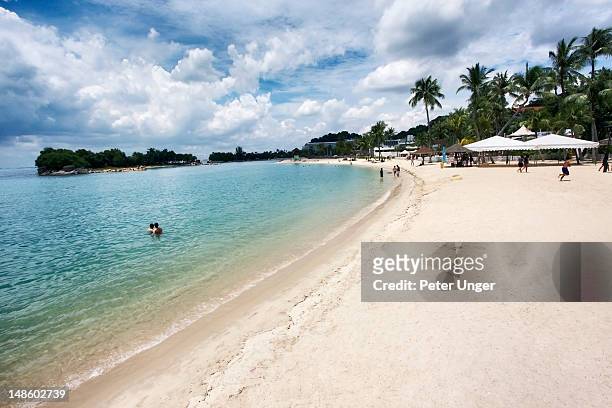 siloso beach at sentosa island. - sentosa island singapore stock pictures, royalty-free photos & images