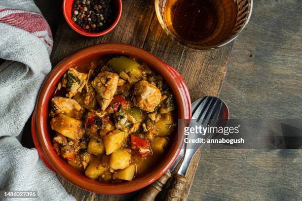 chicken stew with vegetables and a glass of orange wine - chicken stew stock pictures, royalty-free photos & images