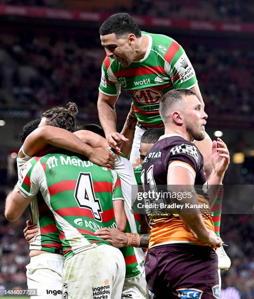 Graham Campbell of the Rabbitohs is congratulated by team mates after scoring a try during the round nine NRL match between Brisbane Broncos and...