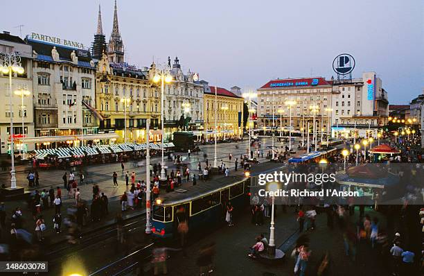 overhead of josip jelacica square and trams on ilica st at dusk. - zagreb tram stock pictures, royalty-free photos & images