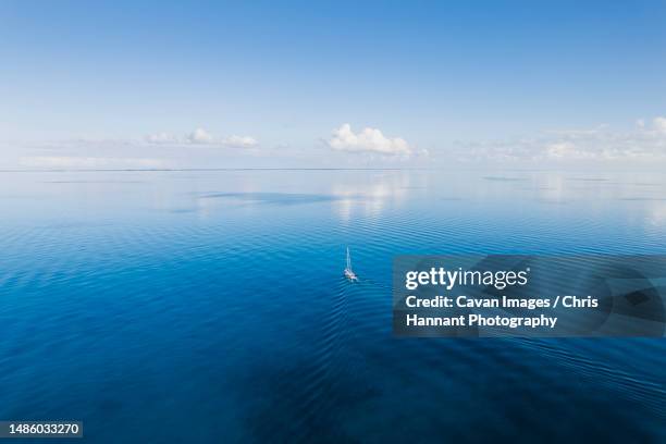 aerial of sailboat in flat calm seas in the bahamas - berry islands stock pictures, royalty-free photos & images