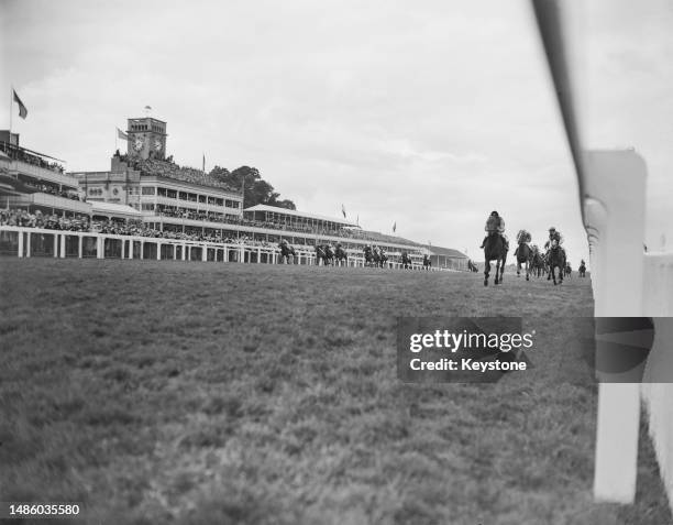 Queen Elizabeth II's horse, Choir Boy, ridden by Doug Smith, winning the Royal Hunt Cup at Ascot racecourse, 17th June 1953. Behind him are the...