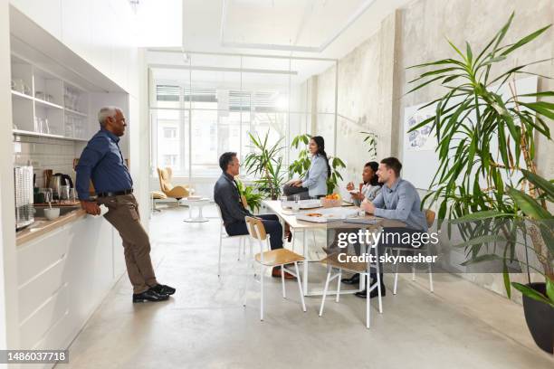 happy business colleagues talking on a break in cafeteria. - canteen stock pictures, royalty-free photos & images