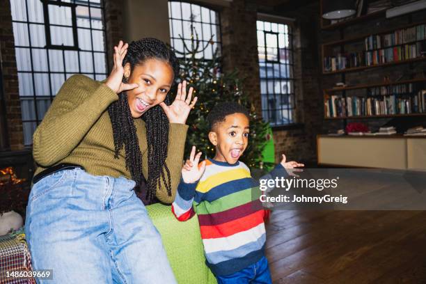 brother and sister gesturing, laughing, having fun - making a face stock pictures, royalty-free photos & images