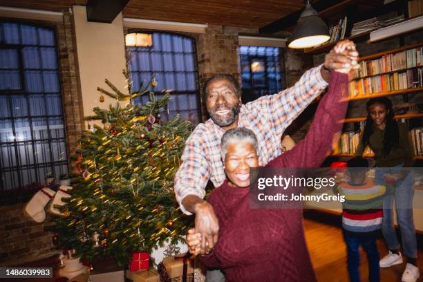 senior black couple dancing on christmas - annual companions stock pictures, royalty-free photos & images