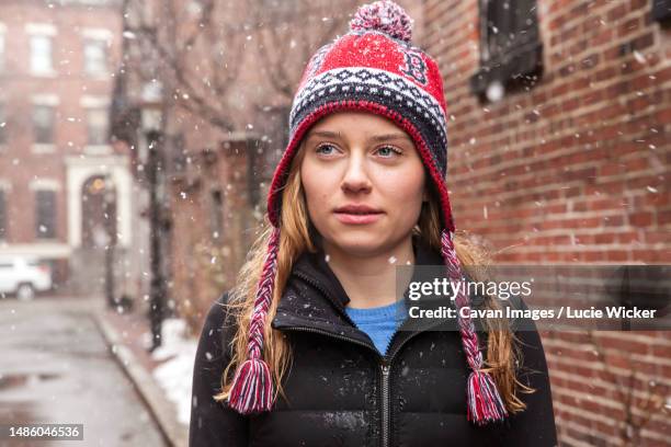 girl in knit hat standing in the snow - boston blizzard stock pictures, royalty-free photos & images