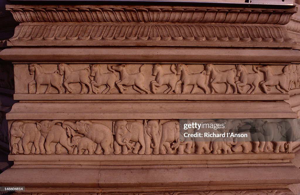 Bas-relief detail of elephants and horses carved in marble on a shrine in the grounds of the Digambara Jain Temple.